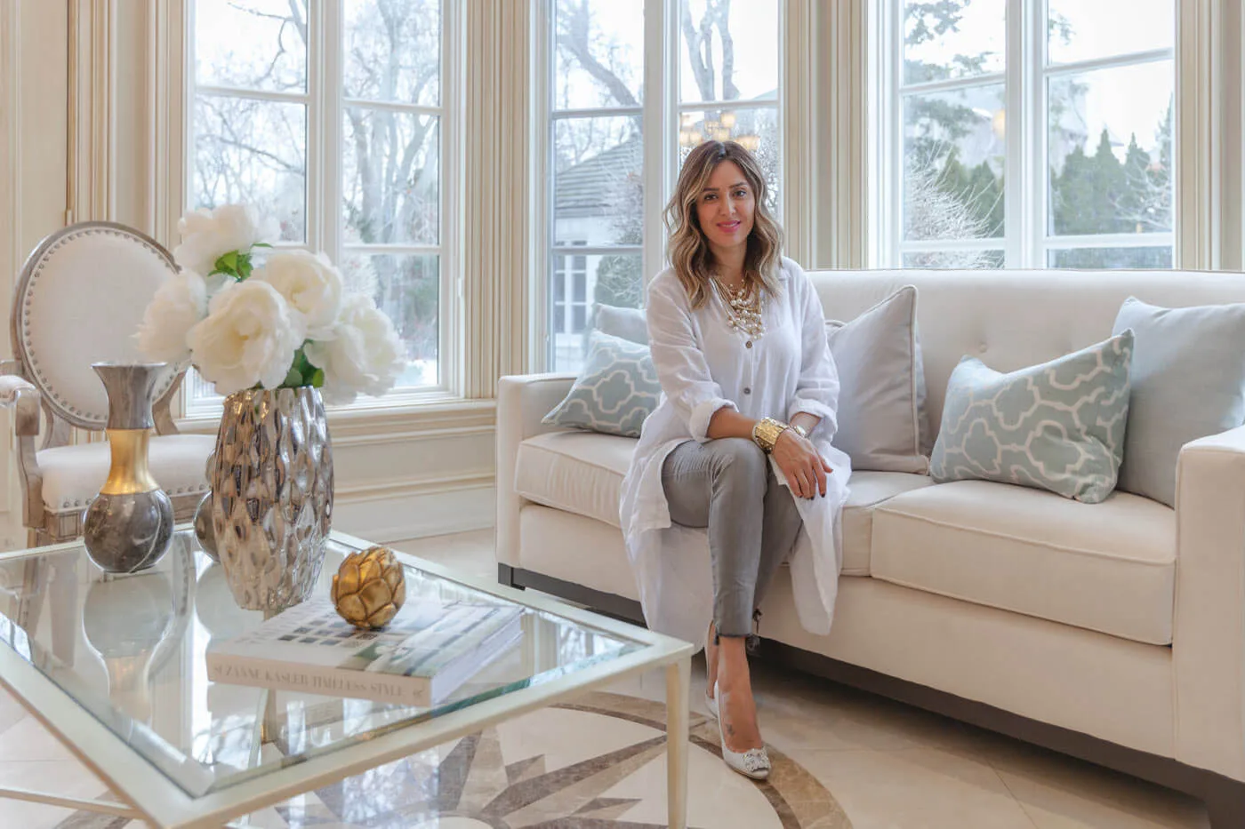 Sanaz Nouri, principal designer, seated in a staged Toronto living room